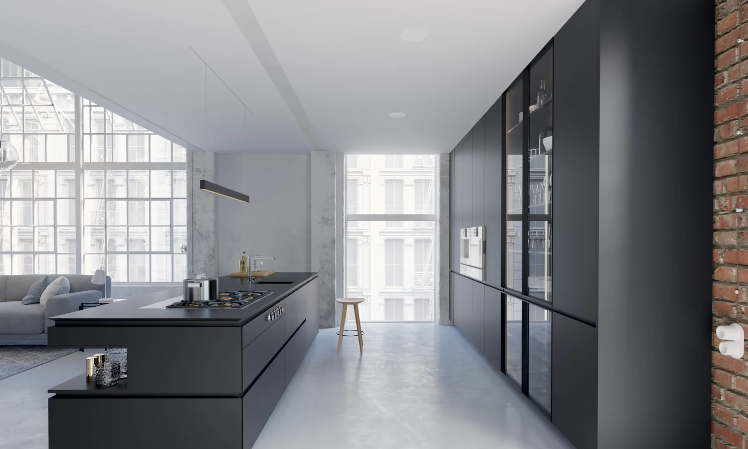 A black galley kitchen in a loft with a single KEF in-ceiling speaker, the only thing on the ceiling