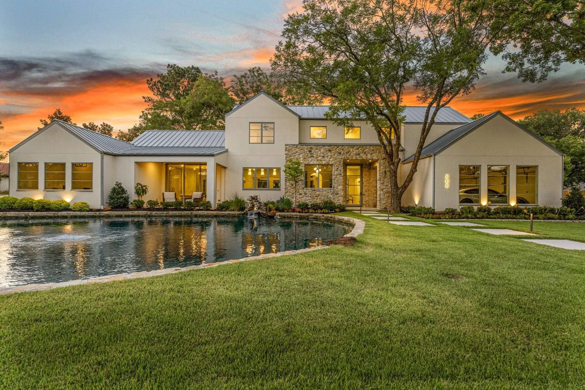 Custom residence in Colleyville, Texas at dusk with architectural and landscape lighting on