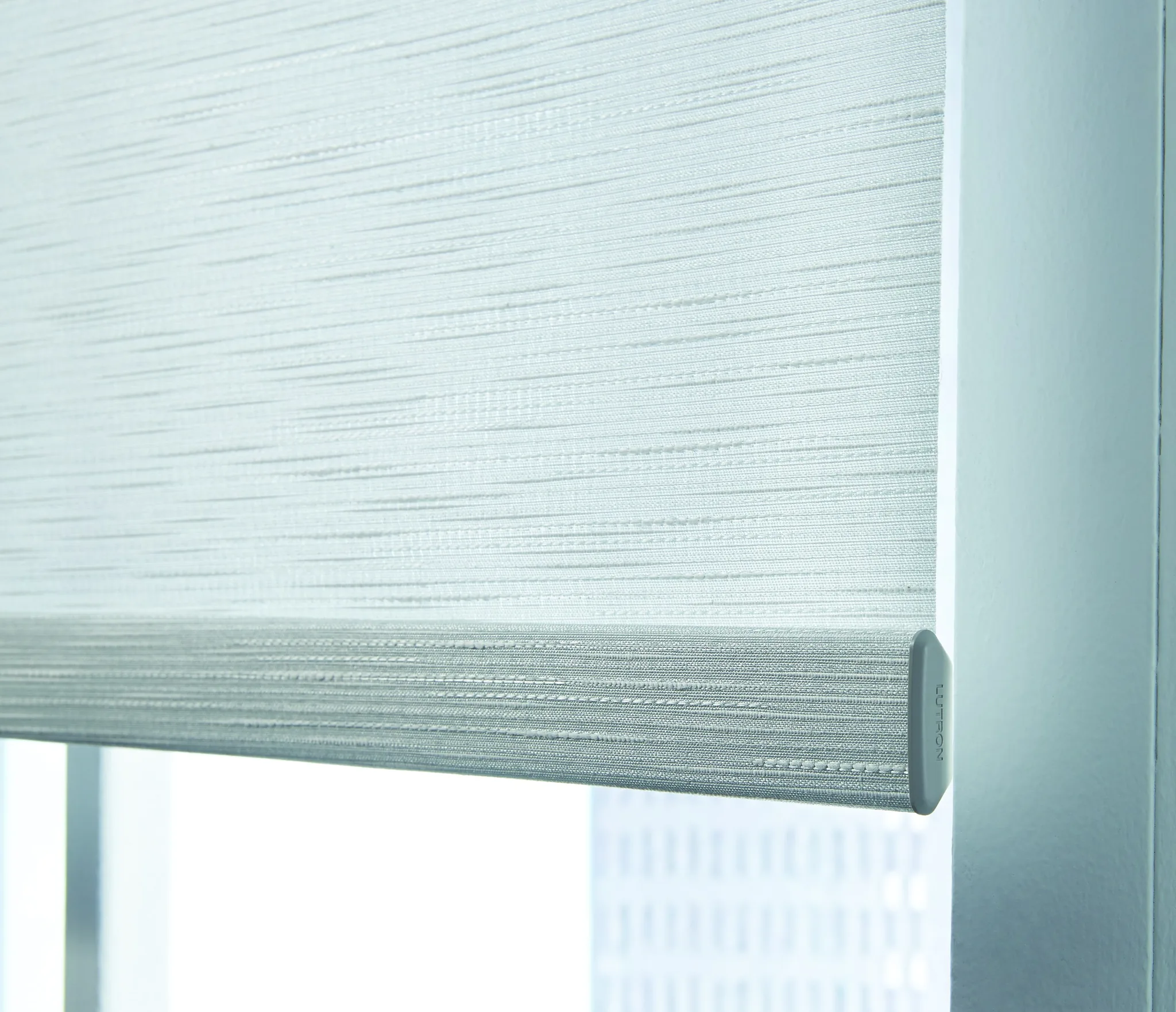 Sivoia QS — The hembar of a Sivoia QS shade in Atelier fabric against a bright window
